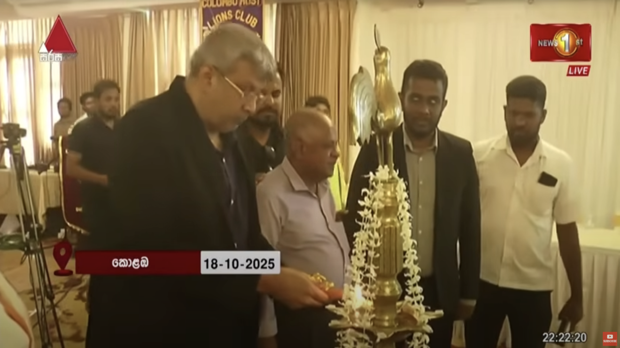 A group of people lighting a traditional oil lamp during the White cane day celebration and the career and education fair, with the News 1st live broadcast