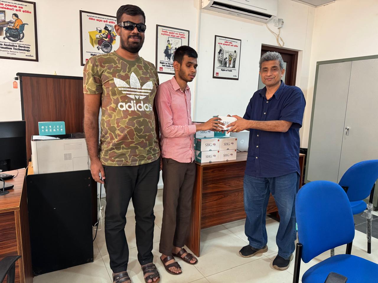 Presentation of Smart Vision glasses to a visually impaired student by a representative in Sri Lanka, coordinated by Sri Lanka Council of Vision Impaired Graduates